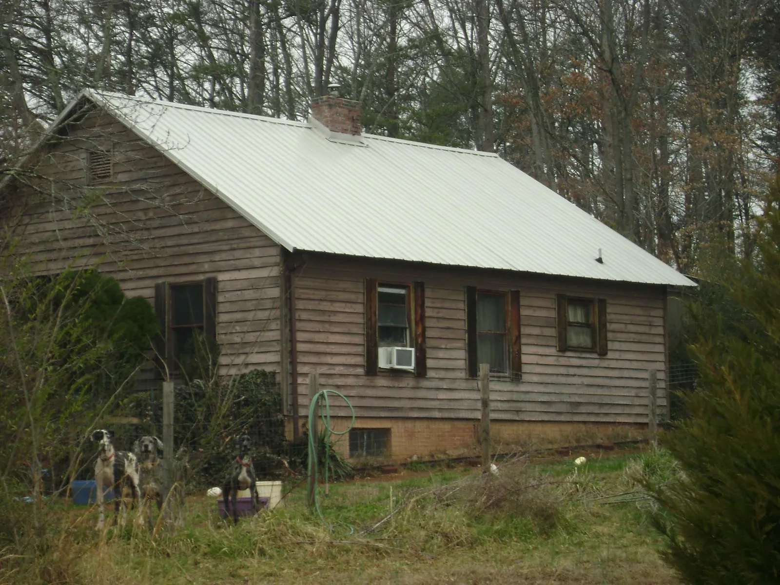 White metal roof on an old wood sided farmhouse, from a Metal Roof Installation job in Fincastle